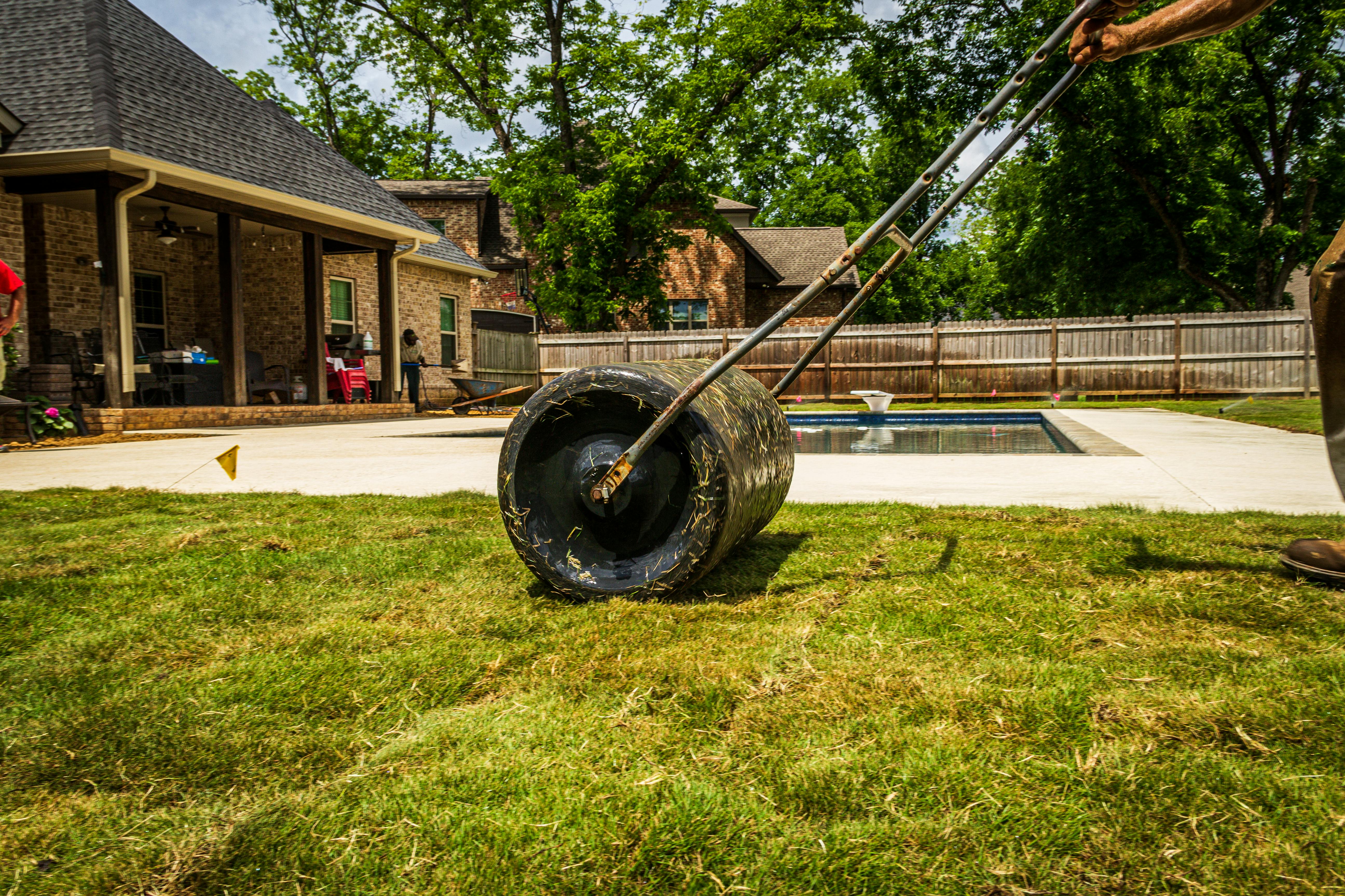 Sod roller being used to press new grass into soil during installation in Fort Worth TX